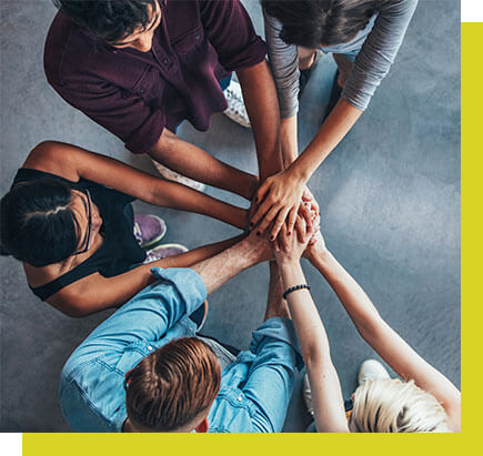 people gathering hands together as a symbol of a strong team